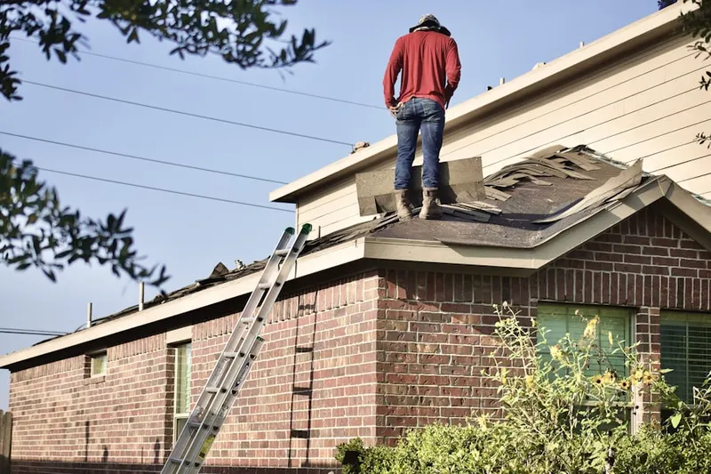 Professional roofer working on a residential roof in Homestead Meadows South